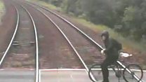 Cyclist's near-miss with train on CCTV