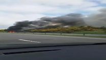 Car on fire causes road closure