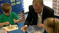 Tim Farron 'squidges' dough at school