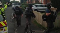Armed police raid Manchester homes