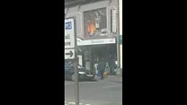 Shoppers walked past early stages of blaze