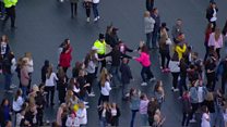 Police officer dances with children at One Love