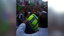 Policeman dances with cricket fans