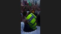 Policeman dances with cricket fans