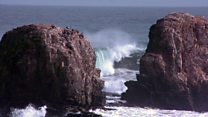 Surfers fighting building on Chilean coast