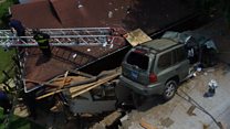 Speeding car lands on roof of house