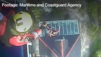 The coastguard helicopter crew winch people to safety