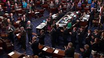 McCain enters Senate to cast deciding vote