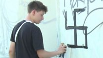 Berlin street artists tackle swastikas