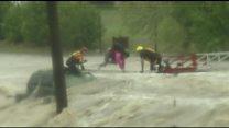 Driver crawls across ladder in US floods