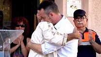 Grieving father's hug with imam