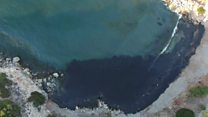 Oil spill turns Greek island bay black