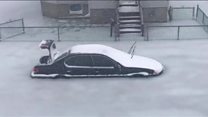 Cars frozen in floodwaters
