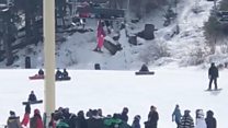Crowd catches girl from ski lift fall