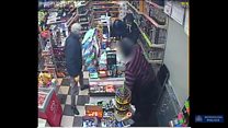 Moment shopkeeper fights off armed robber