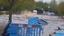 Burst water pipe submerges street