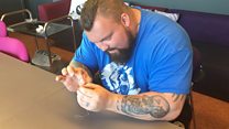 Strong man does delicate tasks