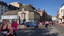 Car driven through half marathon course