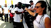 Volunteers give out food on rescue ship