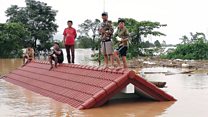 Laos villagers stranded on rooftops