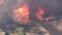 California wildfire tears through homes