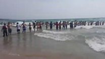 Human chain forms to save swimmers