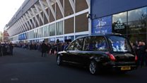 Fans pay respects at footballer's funeral