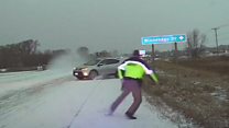 Icy escape: Officer avoids sliding car