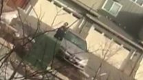 Police confront man picking up rubbish