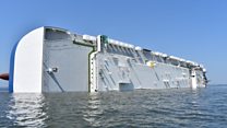 Trapped crew rescued from capsized cargo ship