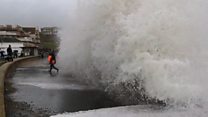 Man carrying child almost swept into sea