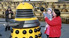 Mum Claire Handy with her baby meets a Yellow Dalek