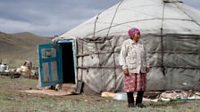 Borbak Dongak waits for the family's herds to appear at the end of their 70km migration