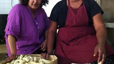 Rupal with a dinner lady making 'matoake' or plantain for school dinners in Uganda.