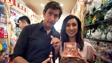 Justin Rowlatt and Anita Rani buy lucky charms for their cars in Tianyi market, Beijing.