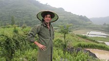 Justin Rowlatt learns how to plant rice in the village of Denggao, Hunan Province, home to members of the Miao ethnic minority.