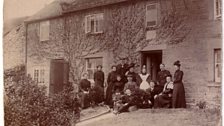 A family posing with a housekeeper