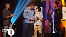 George receives his Teen Hero award from Dev, Louis Smith and Dylan Hartley