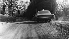 Officer Obie's car at the scene of the crime.