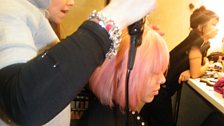 Styling a nice pink wig on the model