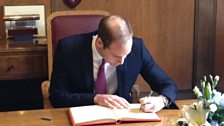 The Duke of Cambridge signs the visitors book at Guildhall.