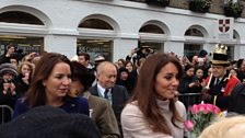 The Duchess of Cambridge accepts flowers from the crowd.