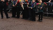 The 29th Cambridge Scouts group follow Kate and collect the flowers she receives.