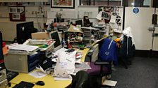 Chris Moyles' desk, under a mountain of free stuff