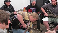 Mike sits at the back of the class - probably for the best given his guitar skills