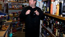 Chris admires the range of beverages behind the counter in the shop