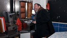 Chris slices some kebab in the Mortons' fish and chip shop