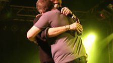 Chris greets star guest Patrick Kielty on stage.