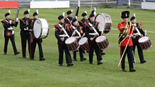 The band lead the players out at the charity football match where Greg, Chris and the team take part in a penalty shoot out