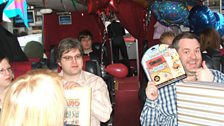 Here we are in the Radio 1 fun bus on the way to Alton Towers, and Chris shows one of his presents to his delighted family...